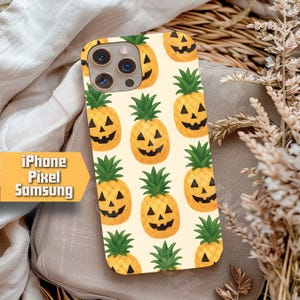 May include: A phone case featuring a repeating pattern of jack-o'-lantern pineapples on a pale yellow backdrop. The pineapples have carved faces and green leafy tops. The case is designed for iPhone, Pixel, and Samsung phones.