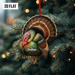 May include: A colorful turkey ornament with a red ribbon for hanging. The ornament features a detailed illustration of a turkey with vibrant green, brown, and red feathers. The name "Jackson" is written on the turkey. The text "2D FLAT" is in the upper left corner.