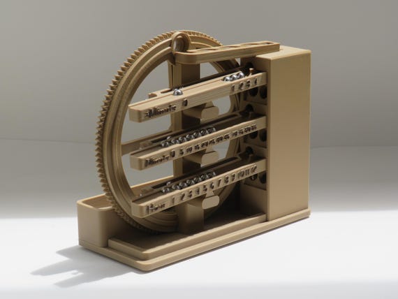A mechanical rolling-ball clock that tells time by moving marbles through tracks — functional timekeeping meets perpetual kinetic art.