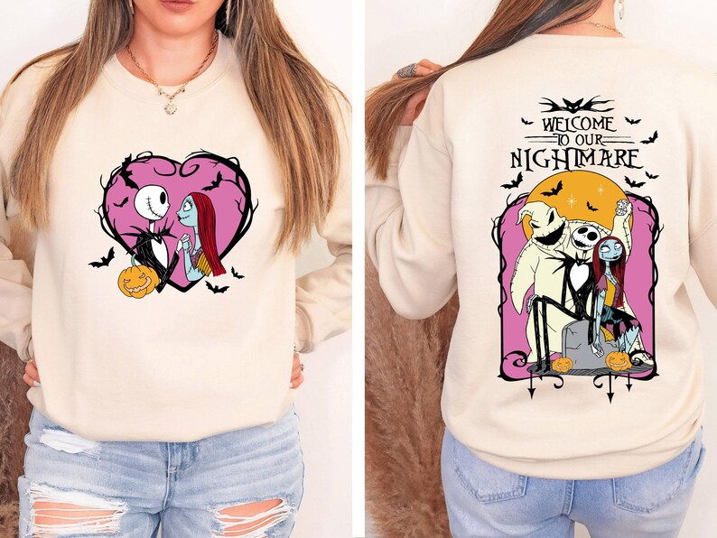 May include: Beige sweatshirt featuring a pink heart design with Jack Skellington and Sally. The back of the sweatshirt has the text "WELCOME TO OUR NIGHTMARE" with Jack, Sally, and Oogie Boogie. Bats and pumpkins are also featured.