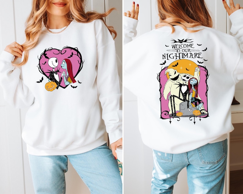 May include: White sweatshirt featuring a heart-shaped design with Jack Skellington and Sally, a pumpkin, and bats. The back of the sweatshirt has a graphic with Jack, Sally, and Oogie Boogie with the text "WELCOME TO OUR NIGHTMARE".