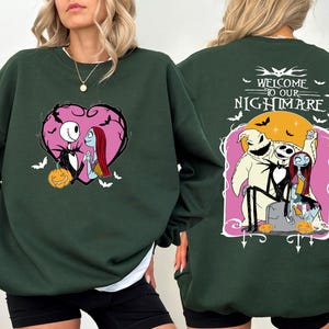 May include: Dark green sweatshirt featuring a heart-shaped graphic with Jack Skellington and Sally. The back of the sweatshirt has the text "Welcome to our Nightmare" with Jack, Sally, and Oogie Boogie. Includes bats and pumpkins.