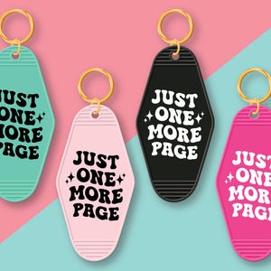 May include: Four keychains with the text "Just One More Page" in a retro font. The keychains are in the shape of motel room keys and are colored pink, green, black, and hot pink.