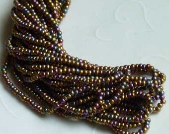 One hank of Czech Silk Dark Bronze Aurora Borealis Finish seed beads - 1013 size 11