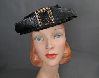 Vintage Black Straw Tilt Hat with Rhinestone Buckle and Straw Bow, 1960s, 21 inch head