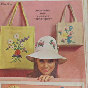 May include: Vintage image featuring a woman and accessories. Two tote bags, one yellow and one beige, are decorated with floral embroidery. A white sun hat with floral accents is also shown. The text reads "ACCESSORIES WITH RICK-RACK 'APPLI-TIQUES'" and "One Size".