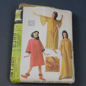 May include: A vintage sewing pattern for misses' and junior robes. The pattern includes three different styles: a yellow robe with a floral design, a pink robe with pom-poms, and a yellow robe with a paisley design. The pattern is from McCall's and is size large.