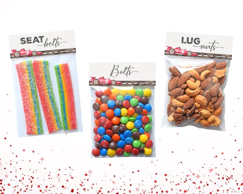 May include: Three clear plastic bags with labels and different snacks. The first bag has red and yellow gummy candies and a label that says "Seat Belts". The second bag has colorful M&M's and a label that says "Bolts". The third bag has almonds and cashews and a label that says "Lug Nuts".
