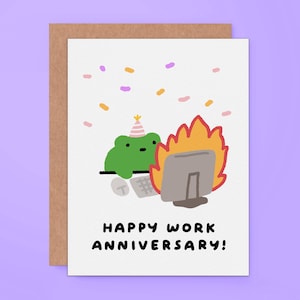 May include: A white greeting card featuring a green frog wearing a pink and white striped party hat, sitting at a computer that is engulfed in orange and yellow flames, with colorful confetti above and the text HAPPY WORK ANNIVERSARY!