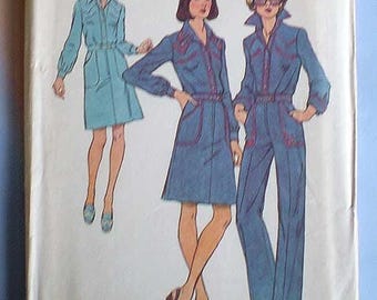 May include: A vintage sewing pattern envelope featuring illustrations of three outfits: a light blue shirt dress, a dark blue shirt dress with red trim, and a dark blue jumpsuit with red trim. The text on the envelope includes the word Miss.