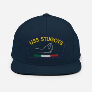 May include: A navy blue baseball cap with a gold embroidered patch that says "USS STUGOTS" and features a hand making the Italian hand gesture with a small Italian flag.