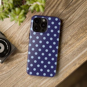 Phone case with light blue polka dots on a navy background in a minimalist preppy design