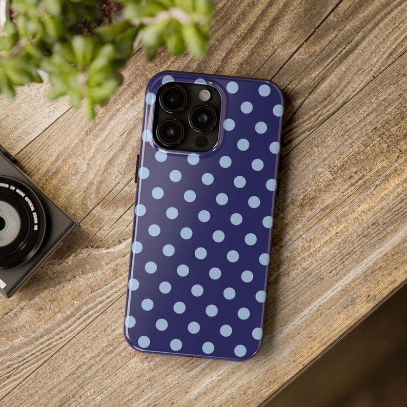 Phone case with light blue polka dots on a navy background in a minimalist preppy design