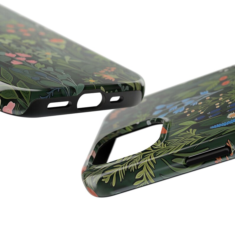 Glossy phone case with a dense botanical illustration of clovers and wildflowers on a dark green background, giving it a woodland cottagecore feel