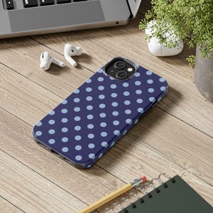 Phone case with light blue polka dots on a navy background in a minimalist preppy design