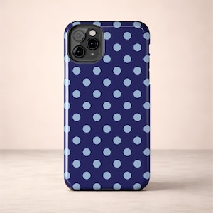 Phone case with light blue polka dots on a navy background in a minimalist preppy design