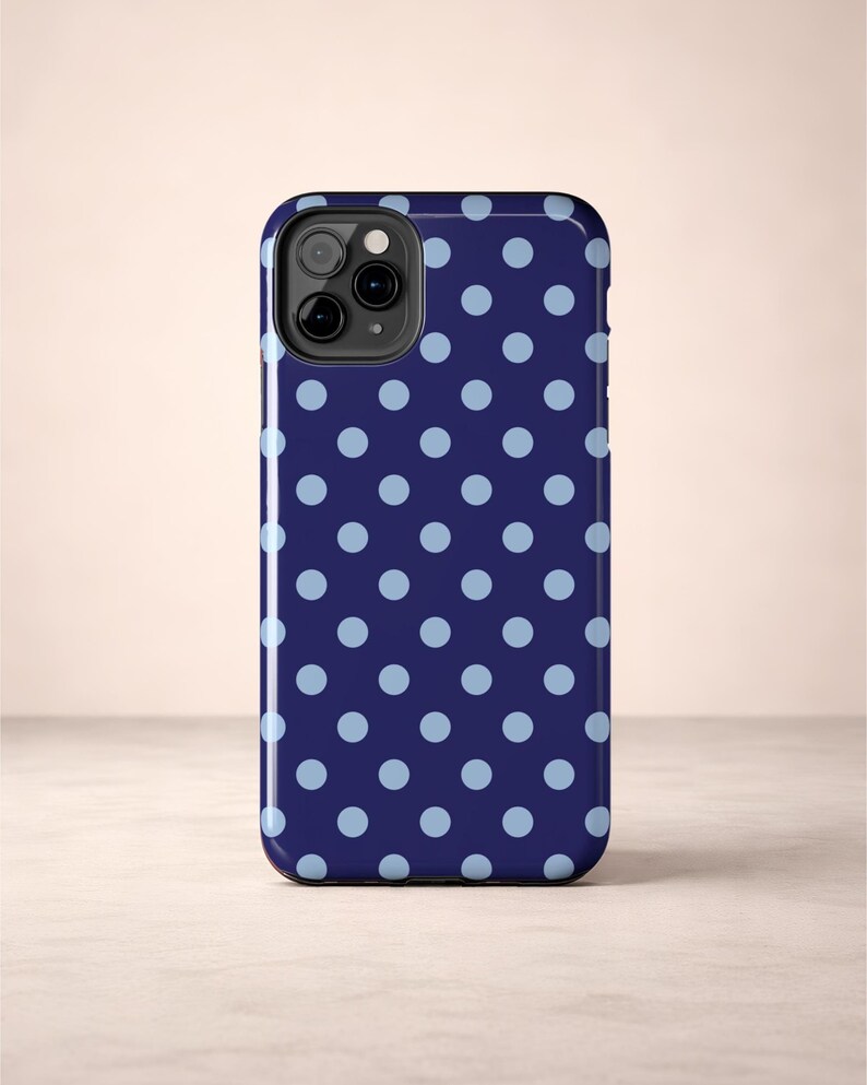 Phone case with light blue polka dots on a navy background in a minimalist preppy design