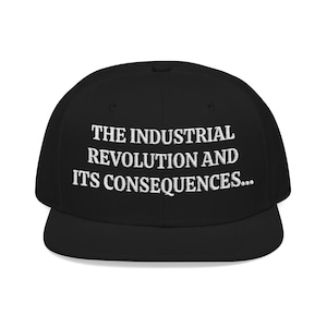 May include: Black baseball cap with a flat peak. The cap has white embroidered text: "THE INDUSTRIAL REVOLUTION AND ITS CONSEQUENCES...". A classic style hat, suitable for casual wear.