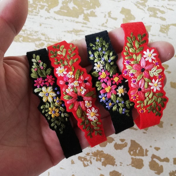 Embroidered floral and foliage bracelet ribbon and felt with a cut edge.