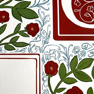 May include: Close-up of a decorative illustration with a white background. Features red roses, green leaves, and blue floral and animal motifs. A red border frames a white space, and a large red letter is visible.