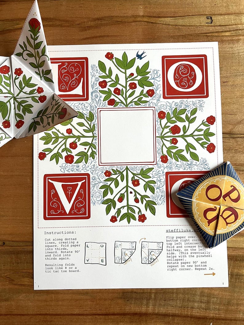 May include: A white paper craft kit with red floral designs, instructions, and a completed star-shaped ornament. The design includes the letters V and O, and the word "LOVE" is visible on a separate piece.