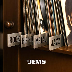 May include: A wooden shelf with a collection of vinyl records, categorized by metal dividers. The dividers are labeled "ROCK", "HIP-HOP", "METAL", and "JAZZ". The logo "JEMS" is at the bottom.
