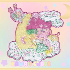 May include: A pink and yellow embroidered patch featuring a cartoon character riding a crescent moon with a rainbow TV on top. The character is surrounded by clouds and stars. The patch has a kawaii aesthetic.