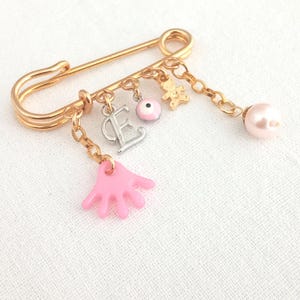 Personalized initial safety pin for the newborn baby girl gift. Newborn safety pin baby carriage gift. Grandmother gives to newborn gift