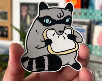 Raccoon Eating Sliced Bread Vinyl Sticker