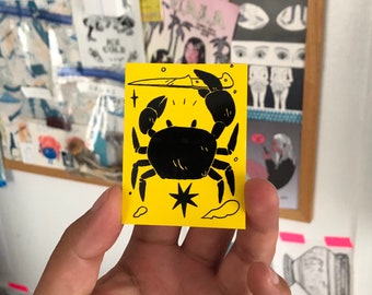 Crab with Knife Black on Yellow Vinyl Sticker by Deth P. Sun