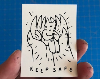 Keep Safe Cat in Hand Vinyl Sticker by Deth P. Sun