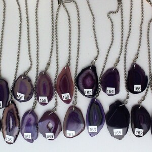 May include: Twenty agate slices on silver chains, each with a unique purple and white pattern. The slices are numbered 150 to 170.