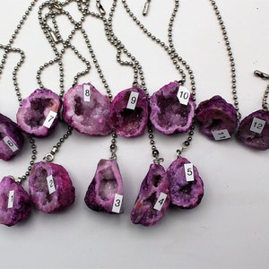 May include: Twelve purple and white crystal geodes on silver chains. Each geode is numbered 1 through 12.