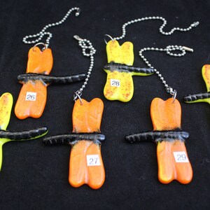 May include: Six colorful dragonfly-shaped light pull chains with black accents. The chains are numbered 25, 26, 27, 28, 29, and 30.