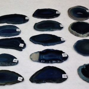 May include: A collection of 12 blue agate slices, each with a unique pattern and shape. The slices are numbered 79 through 92.