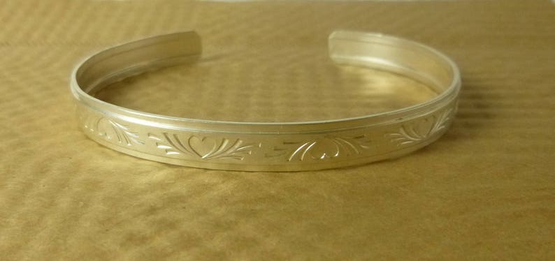 Heart and Flourish patterned sterling silver cuff bracelet in three sizes, from the Love Collection image 5