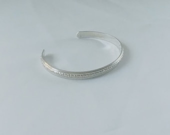 Sterling silver cuff with  flowers that cover this very pretty bracelet that has a fluted edge, part of the Love Collection