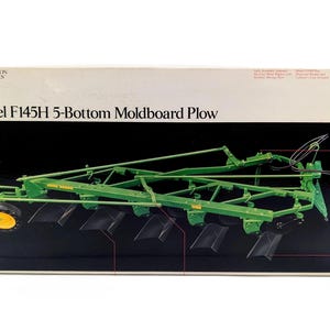 May include: A John Deere Precision Classics Model F145H 5-Bottom Moldboard Plow die-cast metal replica in a box. The green agricultural implement features yellow wheels, black plow blades, and intricate metal framing. The box displays the product name.