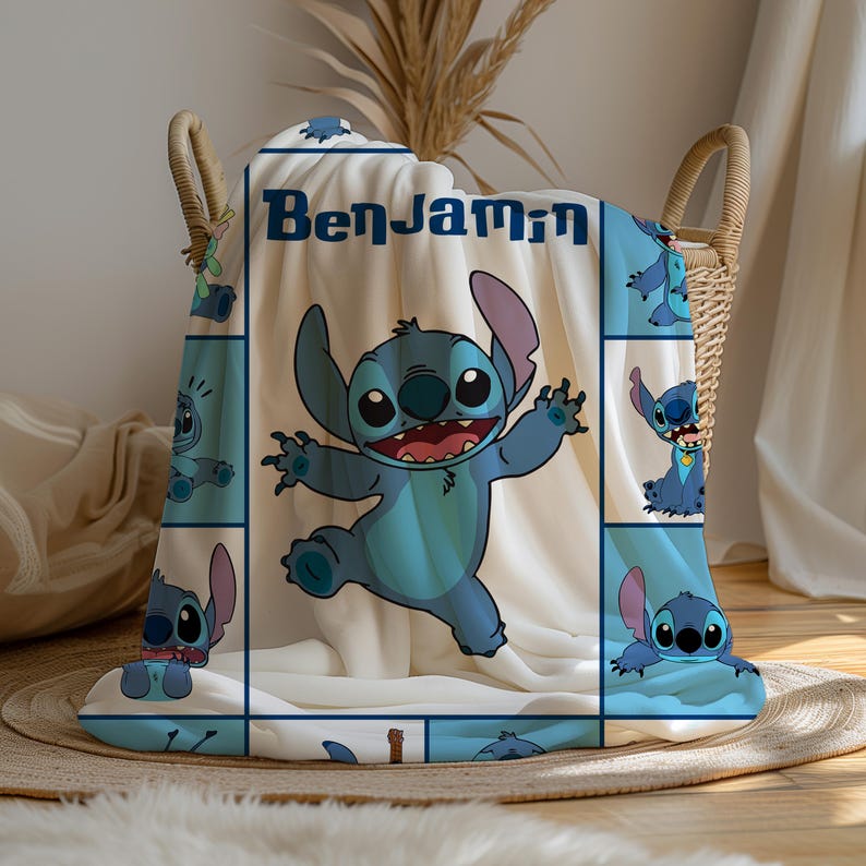 May include: A white fleece blanket featuring a large blue Stitch character in the center and the name Benjamin printed in dark blue text. The blanket includes a grid pattern with smaller illustrations of the same blue character in various poses.