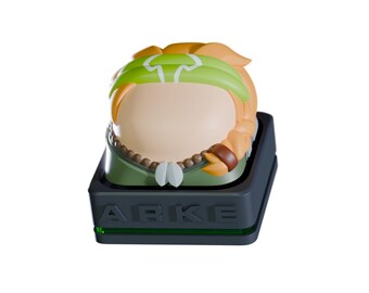 May include: A custom keycap featuring a stylized character with orange hair, a green headband, and a beaded necklace. The keycap sits on a dark gray base with the word "ARKE" and a green light.