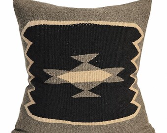 May include: A square throw pillow featuring a textured taupe background with a large central black rectangular panel. The black panel is outlined in a light beige border and contains a stylized geometric bird motif in taupe and light beige.
