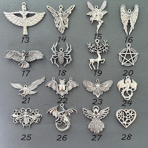 May include: Set of 16 silver charm pendants featuring various designs, including angels, bats, bees, dragons, owls, spiders, and more. The charms are perfect for jewelry making, scrapbooking, and other craft projects.