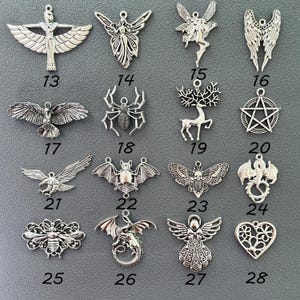 May include: Set of 16 silver charm pendants featuring various designs, including angels, bats, bees, dragons, owls, spiders, and more.