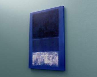 May include: Abstract painting on canvas with a deep blue color palette. The artwork features three horizontal rectangular blocks of color: dark blue, medium blue, and white. The canvas is mounted on a blue frame.