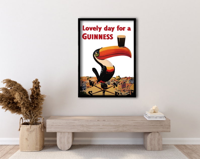 May include: A vintage Guinness advertisement featuring a toucan holding a glass of Guinness with the text "Lovely day for a GUINNESS".