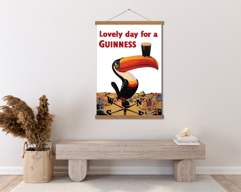 May include: A vintage poster featuring a toucan holding a glass of Guinness beer. The poster reads "Lovely day for a GUINNESS".