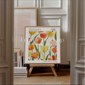 May include: A framed print of a floral design with yellow and orange tulips on a white background. The frame is wooden and has a white mat. The print is titled "HANACO" and is from the HANACO Gallery in Tokyo.