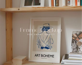 May include: A white framed poster with a drawing of a person wearing a hat and a white dress. The poster has the text "ART BOHEME" and "POSTER NO. 01" on it.