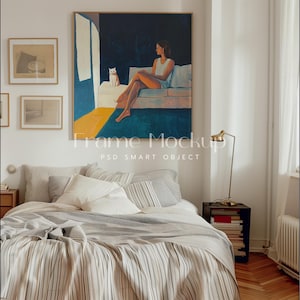 May include: A framed painting of a woman sitting on a couch with a white cat. The painting is in a bedroom setting with a bed, a nightstand, and a lamp.