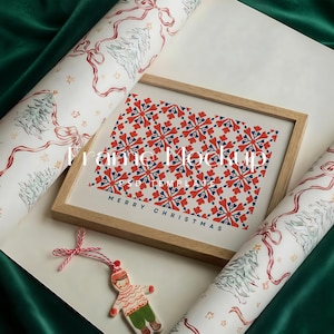 Puede incluir: Una impresión enmarcada en madera con un patrón de copos de nieve rojos y azules y las palabras "MERRY CHRISTMAS". También hay rollos de papel de regalo con temática navideña y un adorno decorativo.